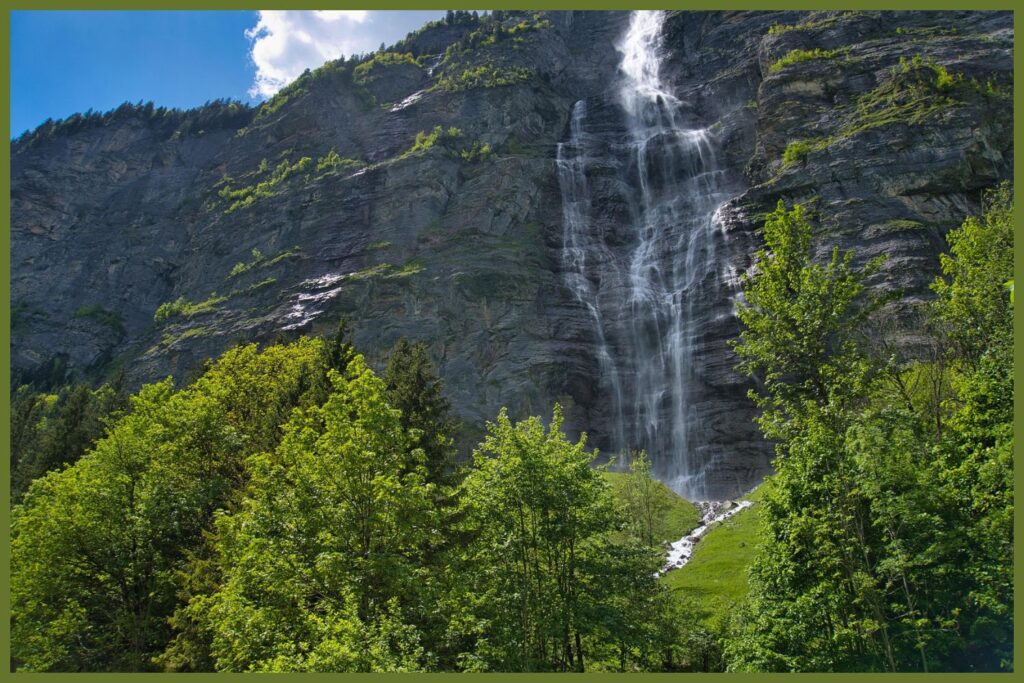 Staubbach Falls cascading down a cliff in Lauterbrunnen Valley on the Geneva to Interlaken road trip