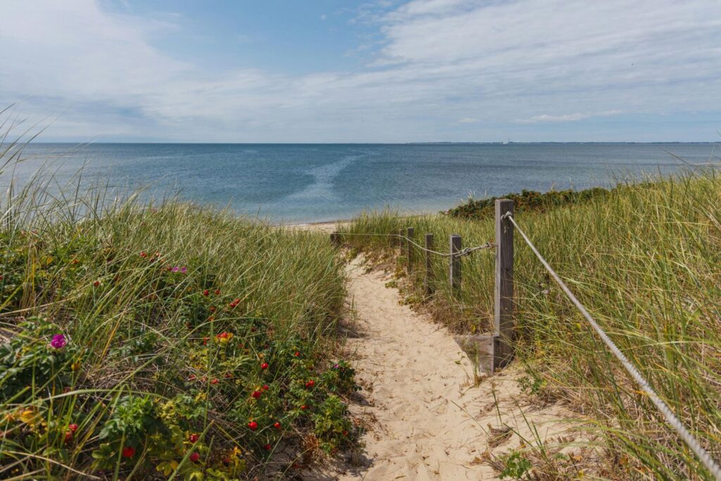 Sandy path through the dunes leading to a quiet beach in Truro, Cape Cod — a peaceful hidden gem among the best beach vacations USA summer 2025.