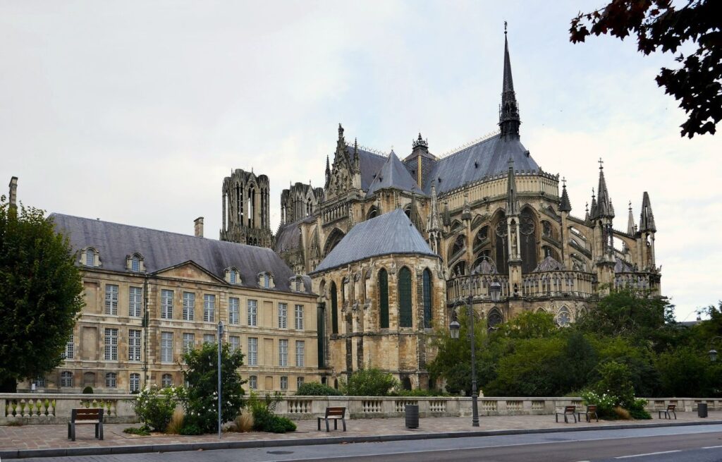 Rear view of Reims Cathedral on a sunny day, featured in the Reims Champagne travel guide