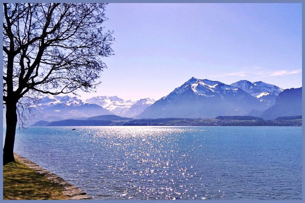 Lake Thun sparkling under alpine sunlight with Niesen mountain in the distance on the Geneva to Interlaken road trip