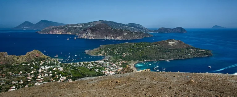 Panoramic view of the Aeolian Islands showing Lipari and Salina from the volcanic heights of Vulcano in Sicily Italy.